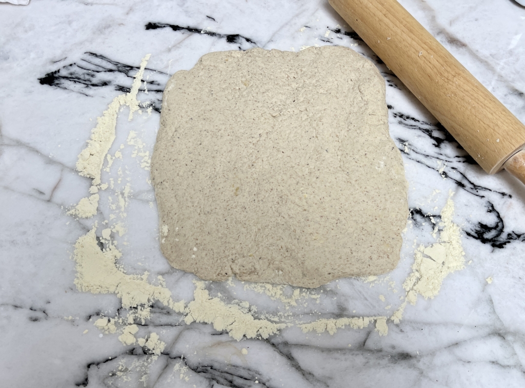 Generously flour your work surface and gently roll out the dough into a rough rectangle, about 10x8½ inches and just over ½ inch thick. 