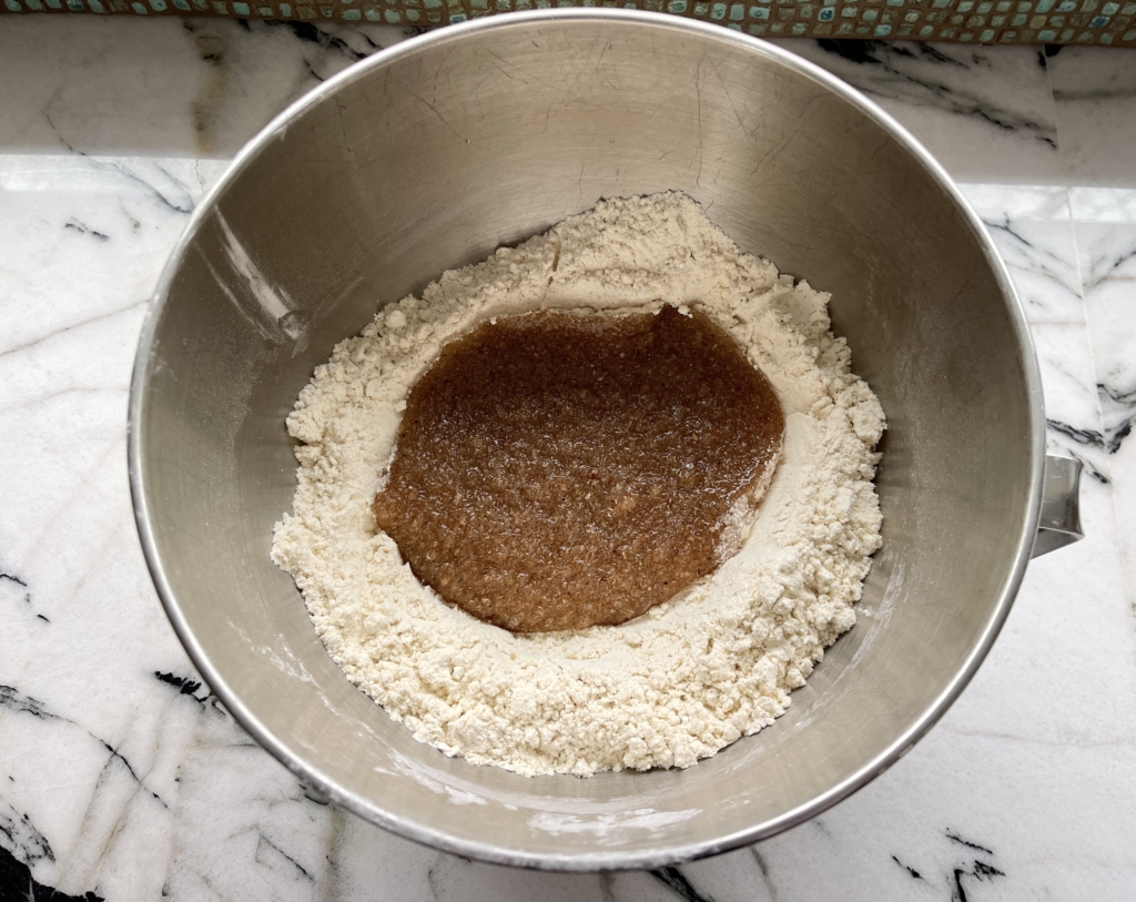 Make a well in the middle of the dry ingredients and add the psyllium gel, olive oil and vinegar.