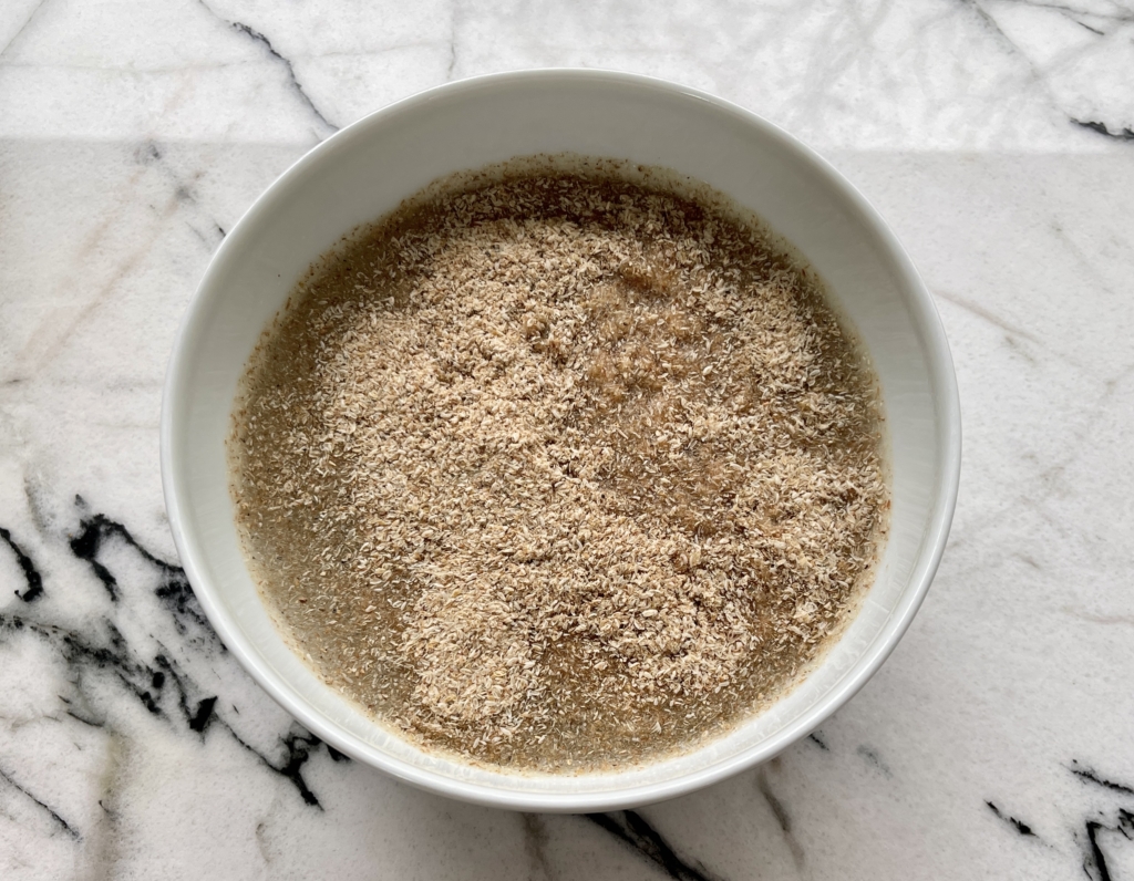 In a smallish bowl, mix together the psyllium husk and lukewarm water. 
