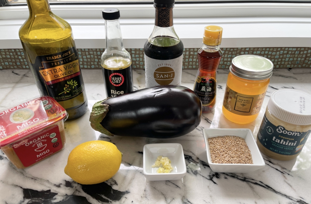 organize ingredients - eggplant, miso, honey, sesame seeds, tahini, garlic, lemon, sesame oil, olive oil, gluten free soy sauce, and rice vinegar.
