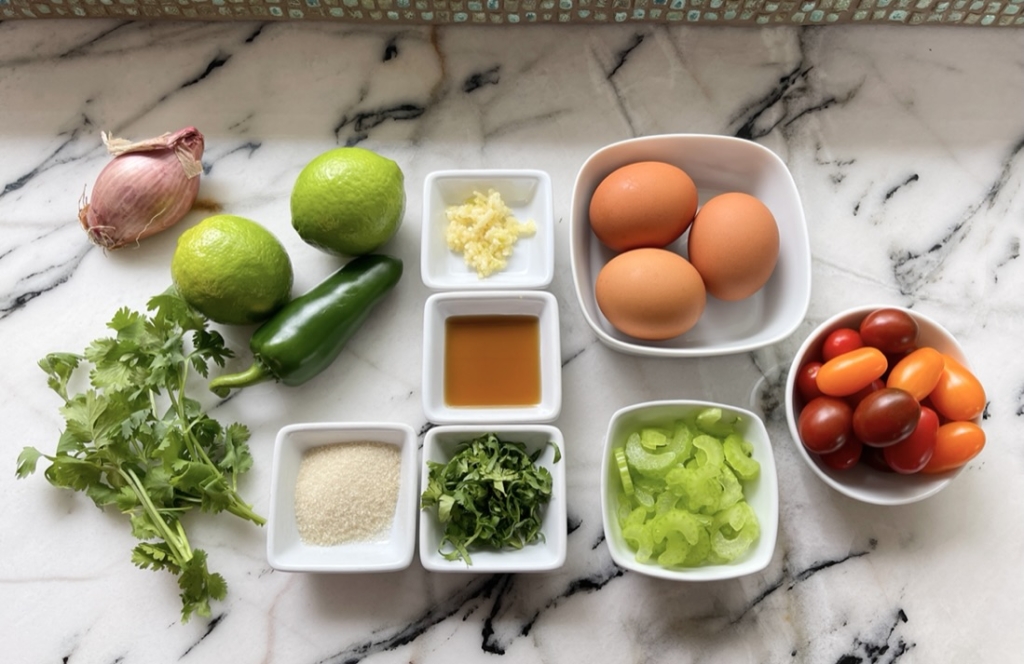 Organize ingredients - eggs, limes, cilantro, shallots, celery, tomatoes, sugar, fish sauce, garlic, hot pepper and olive oil
