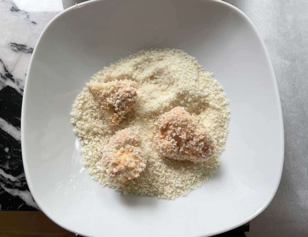 Next, take the batter dipped florets and coat them in the panko crumbs. 