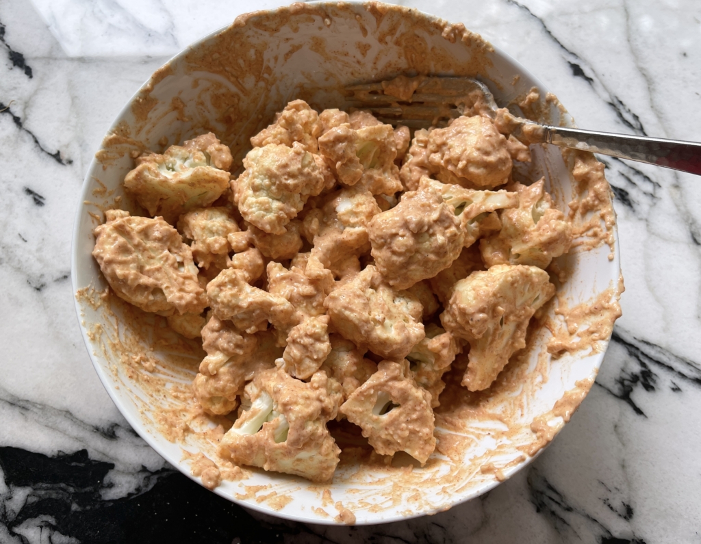 Place the cauliflower florets into the batter making sure florets are thoroughly coated in the batter.