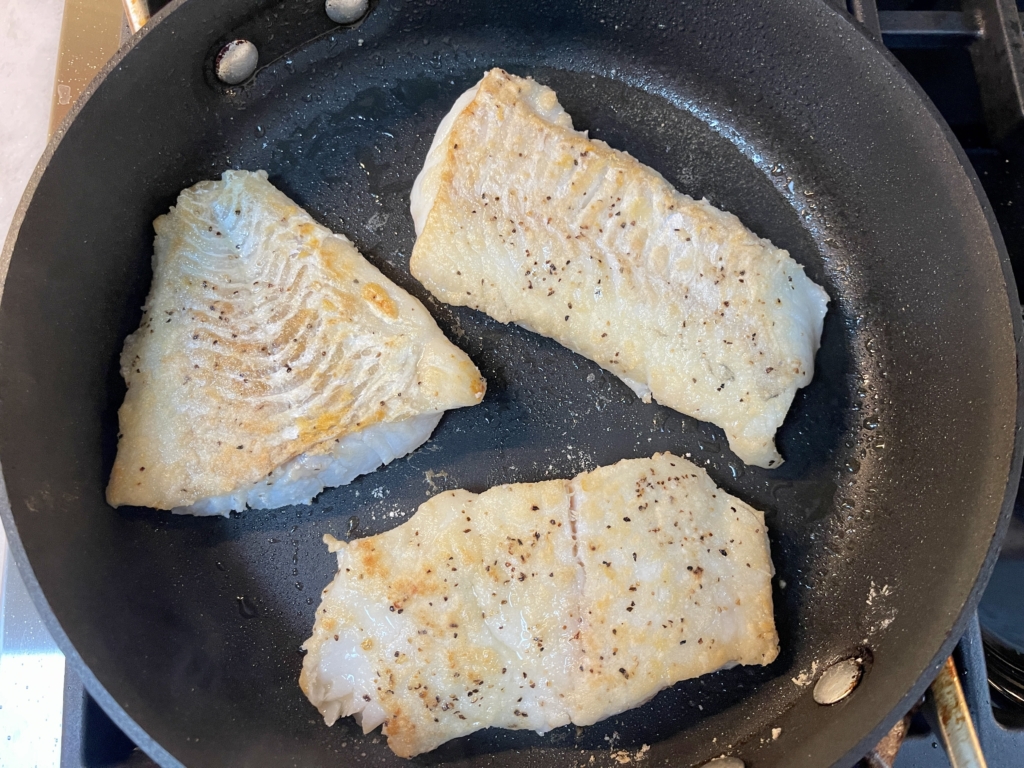 Then flip the fillets and cook for an additional one minute. (If the fillets vary in thickness, cook the thicker fillets for longer and the thinner fillets for less time.) Remove fillets from the pan and place them on a plate.