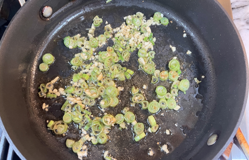 While the florets are cooking, make the sticky sauce. Add sesame oil to a medium sized pan and heat the oil. Once oil is heated, add the white parts of the scallions, garlic, and ginger. Cook for 1-2 minutes until fragrant on medium low heat. 