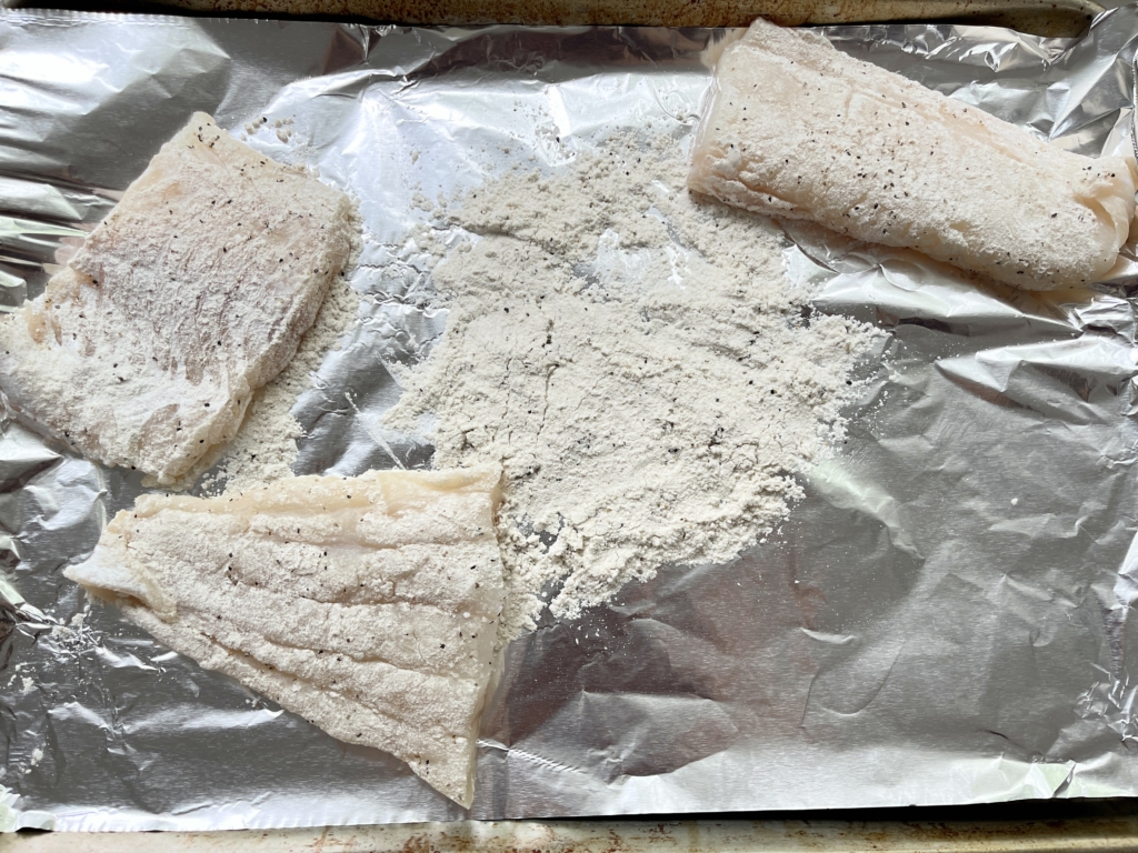 Place gluten free flour on a large plate or on some foil or parchment paper. Add 3/4 teaspoons of kosher salt and ground pepper to the flour and use a fork or your hands to combine. Then dredge each fish fillet into the flour and thoroughly coat.