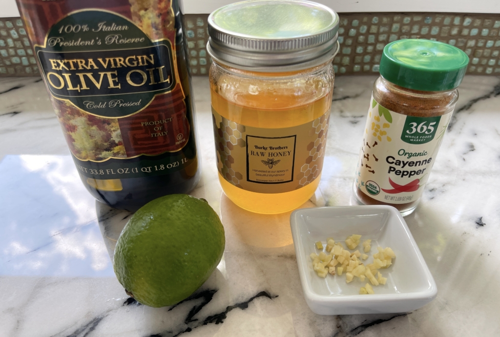 Vinaigrette ingredients - extra virgin olive oil, honey, lime zest, lime juice, garlic, and cayenne pepper.