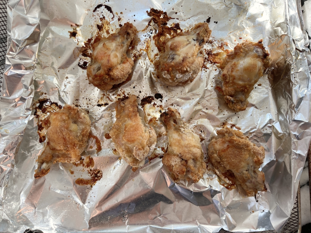 Place the coated wings into the oven or air fryer, turning them over halfway through. if using the air fryer, cook for 25 minutes. The goal is to have golden, crispy wings so cook until this desired result is achieved.