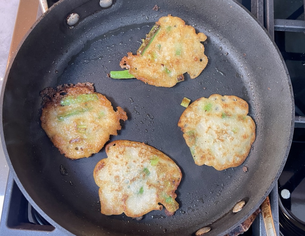 Then carefully flip the pancakes (add more oil if necessary) and cook for an additional minute, or until the bottoms are golden brown and crispy. Transfer pancakes to a plate lined with a paper towel and repeat.