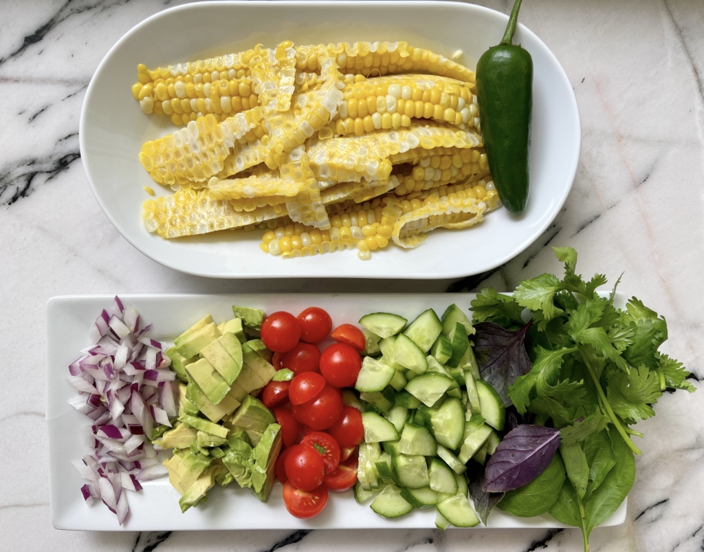 Salad ingredients - corn, onion, avocado, tomatoes, cucumbers, fresh herbs and jalapeño (if you like spice)