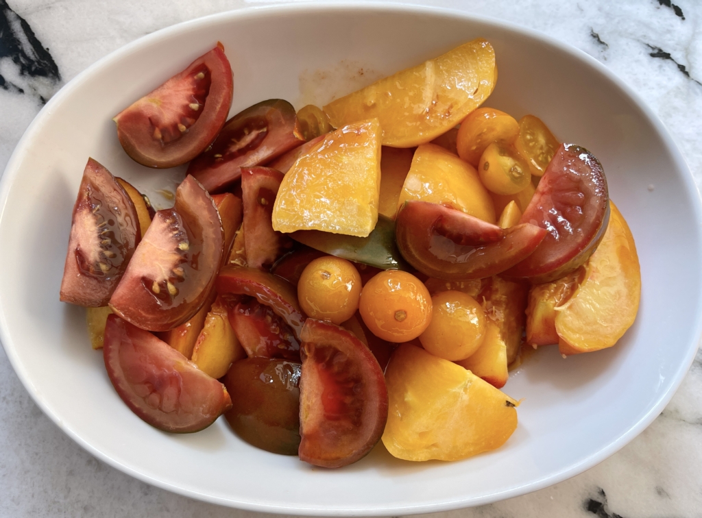 Pour half of the dressing over the peaches and tomatoes and combine. Let sit for 5 minutes.