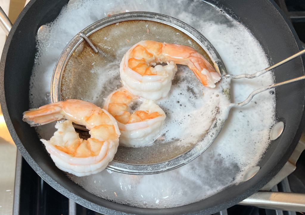 Cook for 1 1/2 minutes, until shrimp turn color and start to float to the top of the pot.