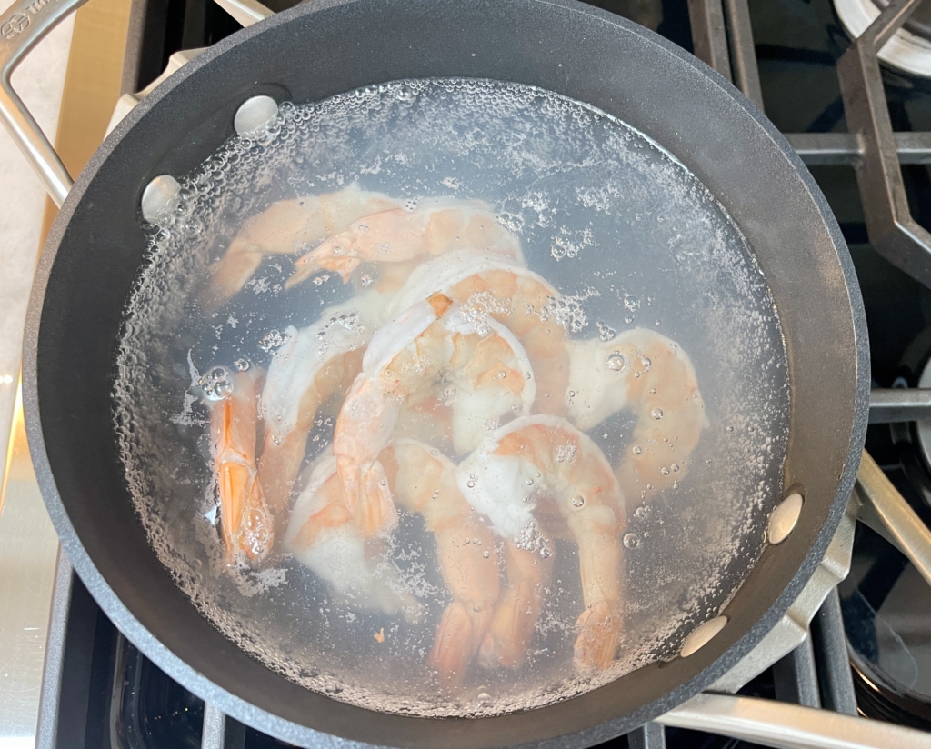 Transfer raw shrimp into salted boiling water in a medium sized pot. 