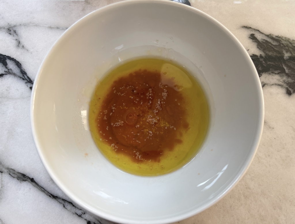 Place oil, hot sauce, vinegar, and honey in a small bowl 