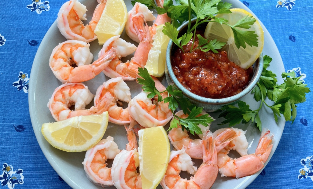 Poppin' Shrimp Cocktail Arrange shrimp on a platter or in a bowl with the cocktail sauce. Garnish with parsley and lemon wedges.