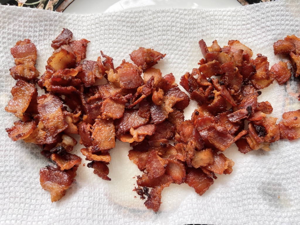 Remove bacon with a slotted spoon and place onto a plate lined with a paper towel.