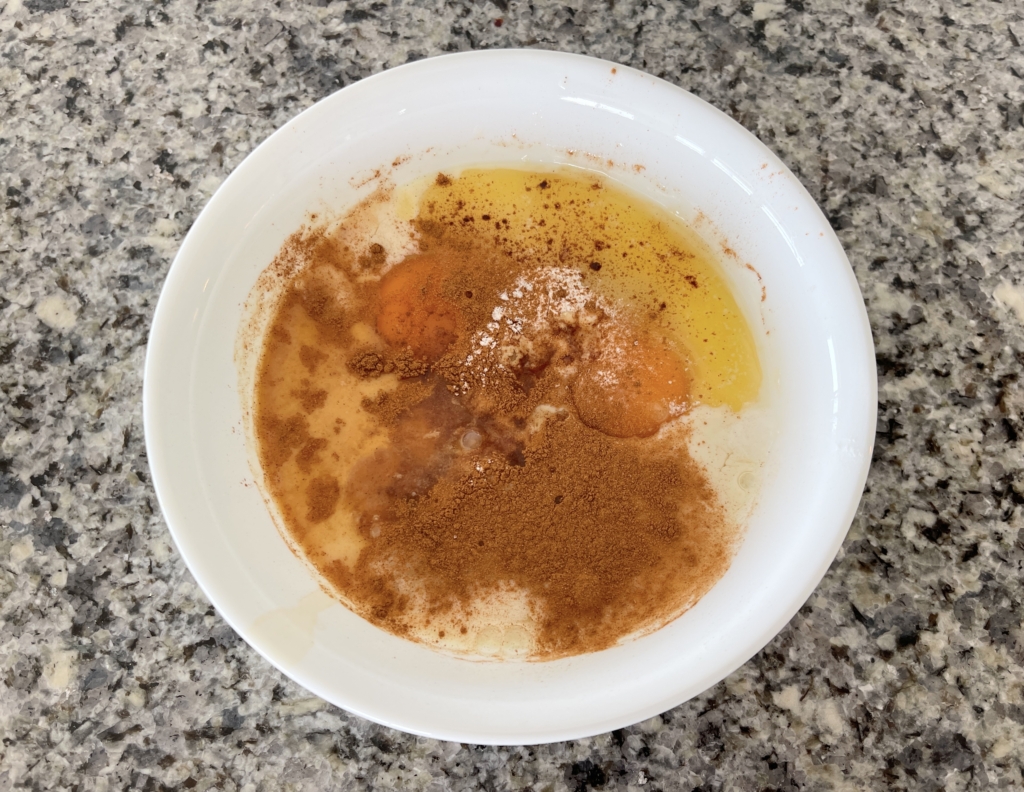 Place eggs, milk, sugar, vanilla, melted butter, cinnamon, and baking powder in a medium sized bowl.