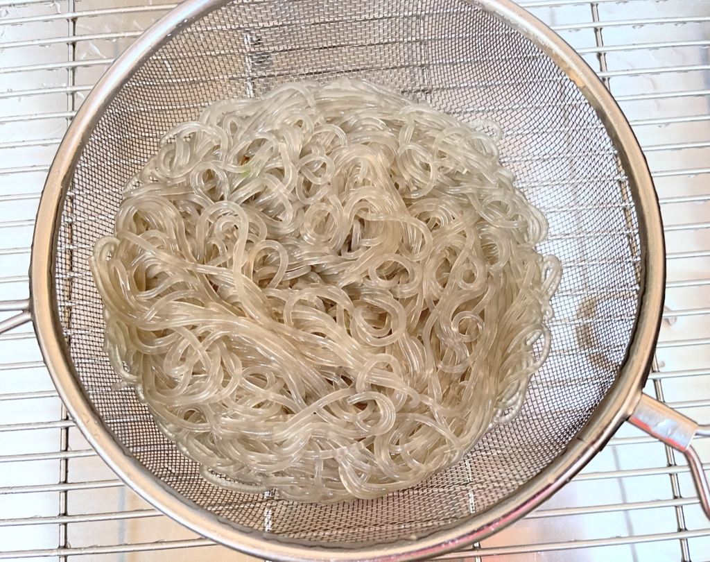 Drain, rinse in cold water and set aside. (If desired, cut the noodles into smaller strands with a scissor.)