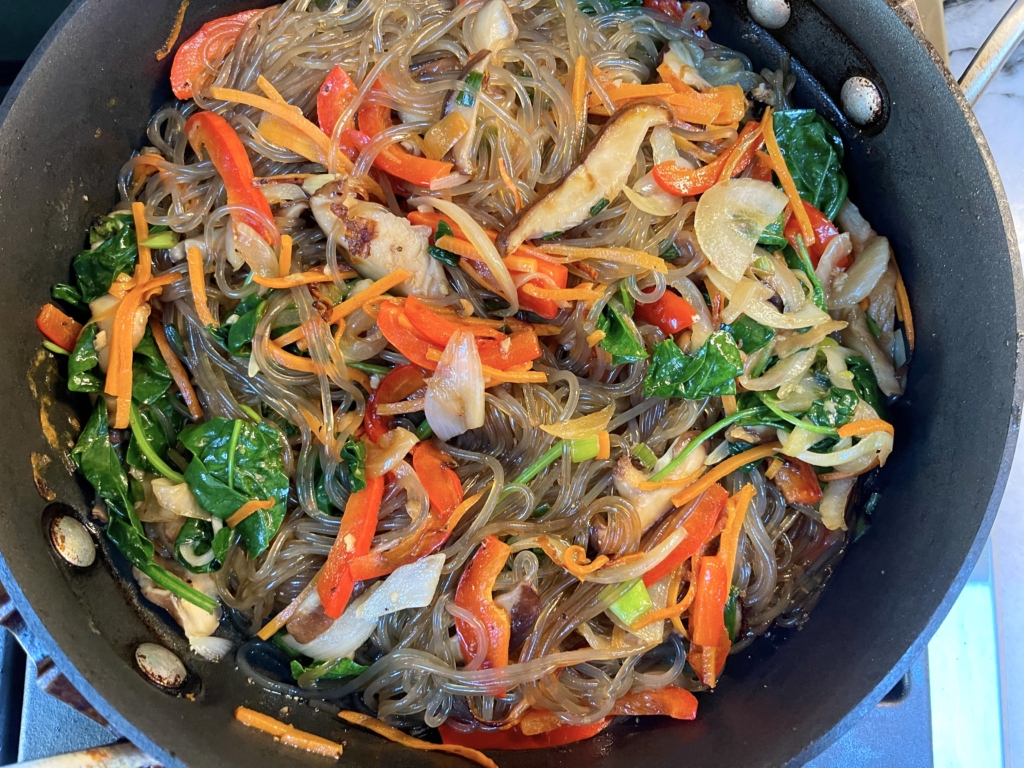 Then add the vegetables and egg strips into the pan and combine all of the ingredients.