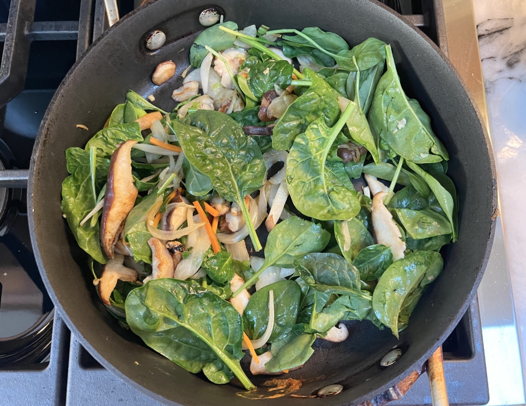 Lastly, add the spinach and cook until spinach begins to wilt, 1-2 minutes. Remove the vegetables from pan and place into same bowl with carrots and peppers.