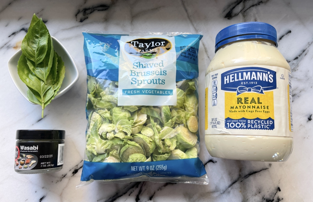 ingredients - package of shaved brussels sprouts, mayo, wasabi powder, cold water, and fresh basil, if desired.