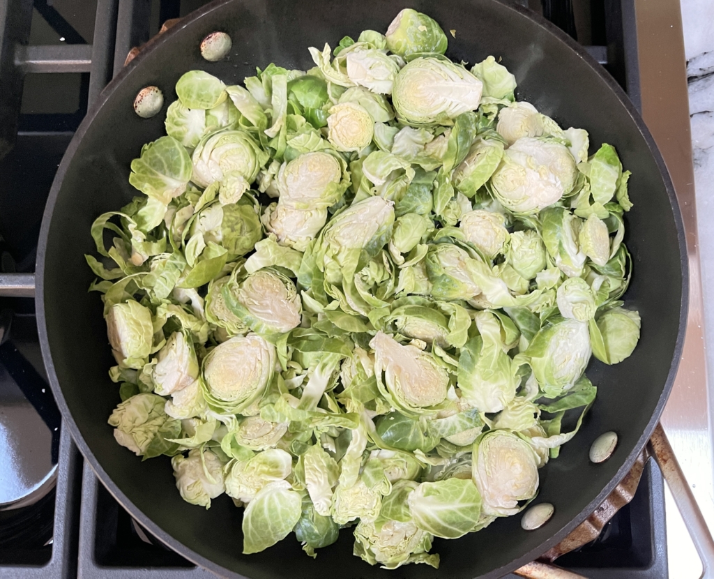 While wasabi is resting, heat oil in a large pan over medium-high heat. Once heated, add Brussels sprouts to the pan and allow to cook undisturbed for approx. 3 minutes. This is an important initial step for browning the Brussels sprouts.