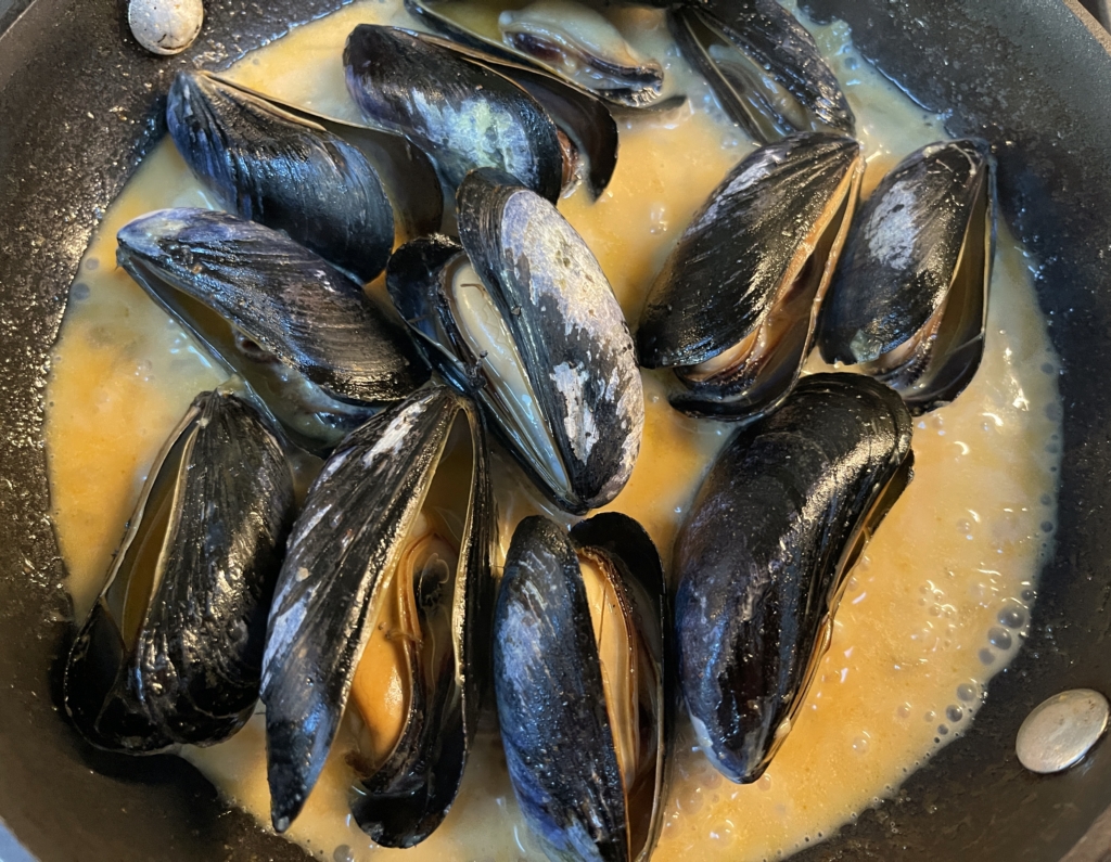 Lastly, carefully add the mussels and cover for 3-5 minutes while the mussels steam and open. If possible, use a glass lid so that you can see when most of the mussels have opened. Once the mussels have opened, they are cooked. Don't overcook! Overcooked mussles become like mush🤮! Discard any unopened mussels. Add lime juice and stir to coat.