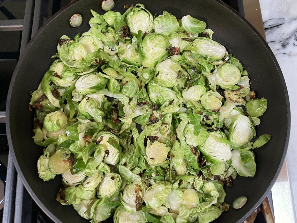 Then toss Brussels sprouts in 1 minute intervals, adding a drop more oil if needed, and seasoning with kosher salt and freshly ground black pepper. The goal is to have the Brussels sprouts browned AND softened so you may need to fine tune the heat of the stove during the last 4 minutes of cooking. Total cooking time is approx. 7 minutes.