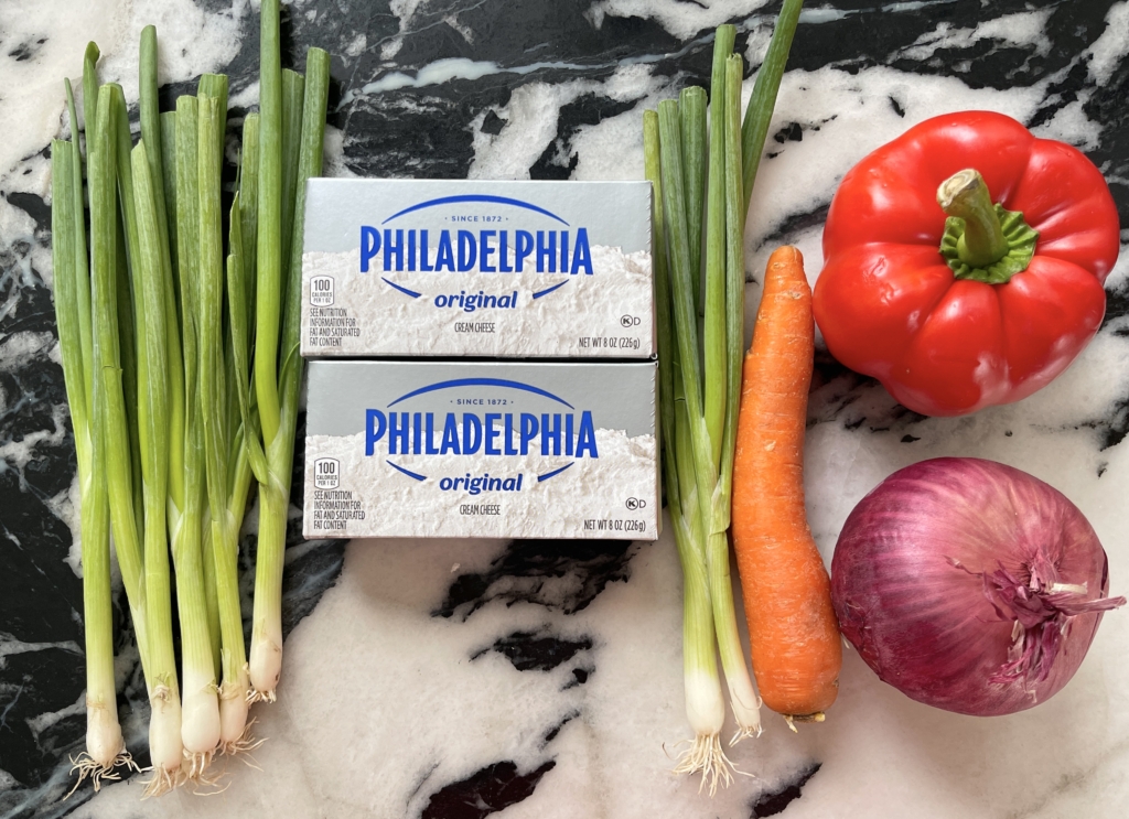 ingredients - philadelphia cream cheese blocks, scallions, red pepper, carrot, and onion.