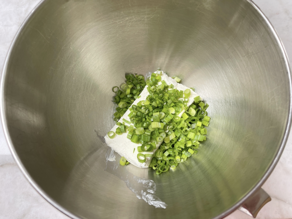 Place scallions and cream cheese in a bowl.