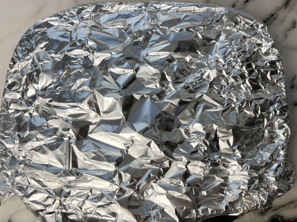 Cover with reserved foil and let sit until butter is mostly melted, 3–4 minutes.