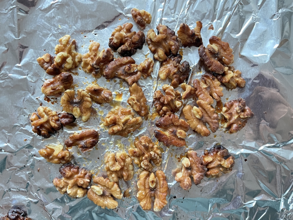 Line a small tray with foil or parchment and preheat oven to 350 degrees.Transfer nuts to the tray and bake for 5 minutes. Let nuts cool for 10 minutes. Nuts can be left whole or chopped; it’s a personal preference.