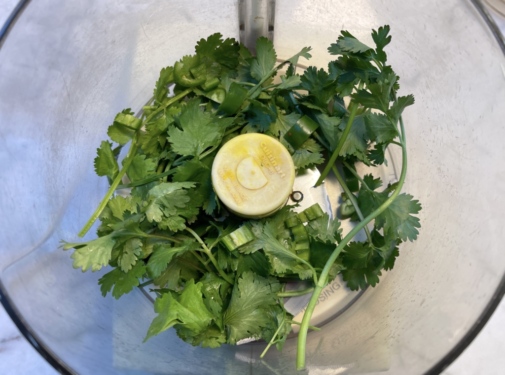 Place chile and cilantro in the food processor and process until ingredients are finely chopped. 