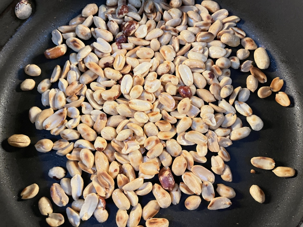 Cook for 3-4 minutes, until peanuts are browned and toasted. 