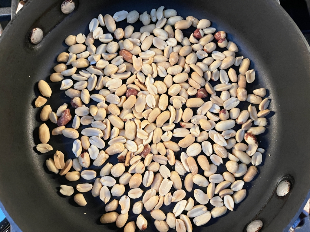 Toast peanuts in same large pan you plan to use to cook the chicken. 