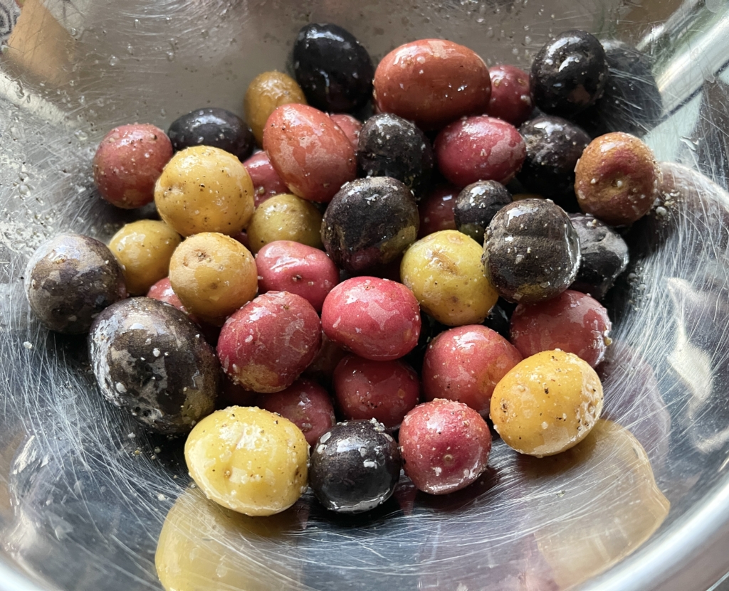 Separately toss baby potatoes, freshly ground pepper, remaining 2 tablespoons extra-virgin olive oil, and kosher salt in a large bowl