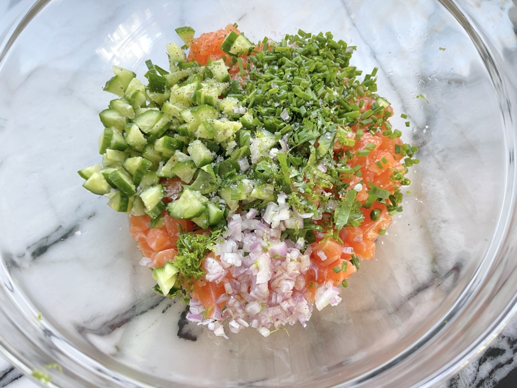 Transfer the salmon to a medium bowl and add the cilantro, chives, shallots, ginger, sesame oil, gluten free soy sauce, lime and orange zest, and honey/mirin.