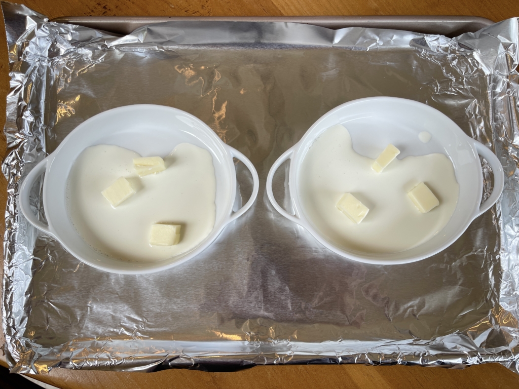 Place one tablespoon of the heavy cream and 1/2 tablespoon of butter (cut into 3-4 pieces) into each ramekin.