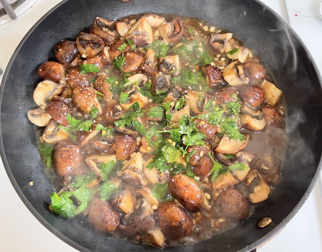 Add the wine, vegetable broth, salt, red-pepper flakes, a few pinches of black pepper and half the parsley. Increase heat to medium-high and cook, stirring occasionally, until the wine has reduced by half and thickened slightly, 3 to 5 minutes.