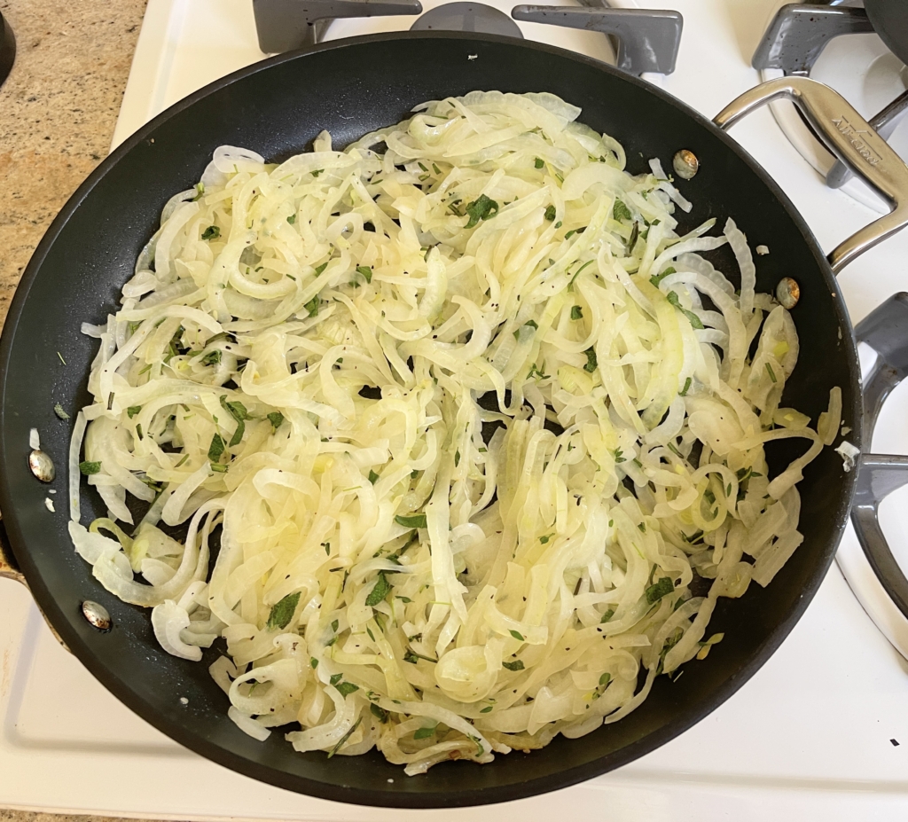 Heat olive oil in a large pan over medium heat. Add onions, fresh herbs, and season with kosher salt and freshly ground pepper.