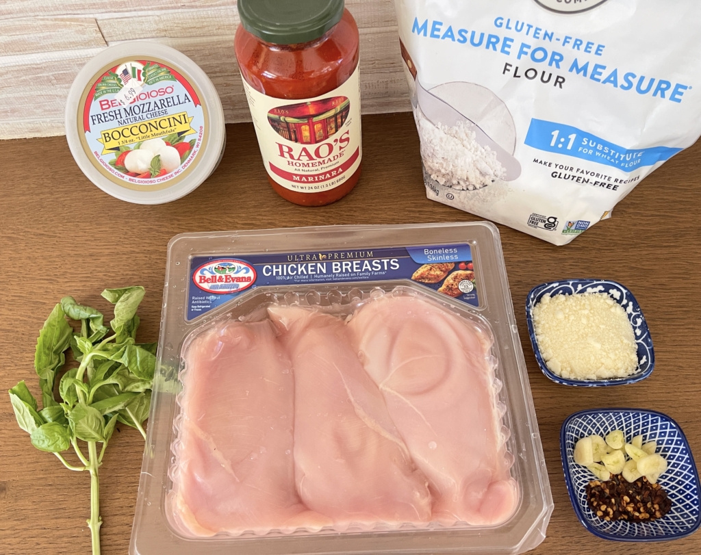 ingredients - chicken breasts, bottled marinara sauce, fresh mozzarella, parmesan, garlic, red pepper flakes, gluten free flour, olive oil, kosher salt, ground pepper, and fresh basil