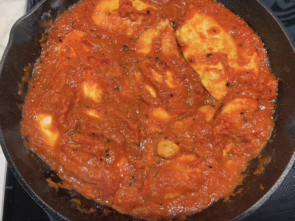 Next, pour the jar of sauce in the pan and reduce the heat to simmer. Heat sauce for 5 minutes. Turn on broiler while sauce is simmering.