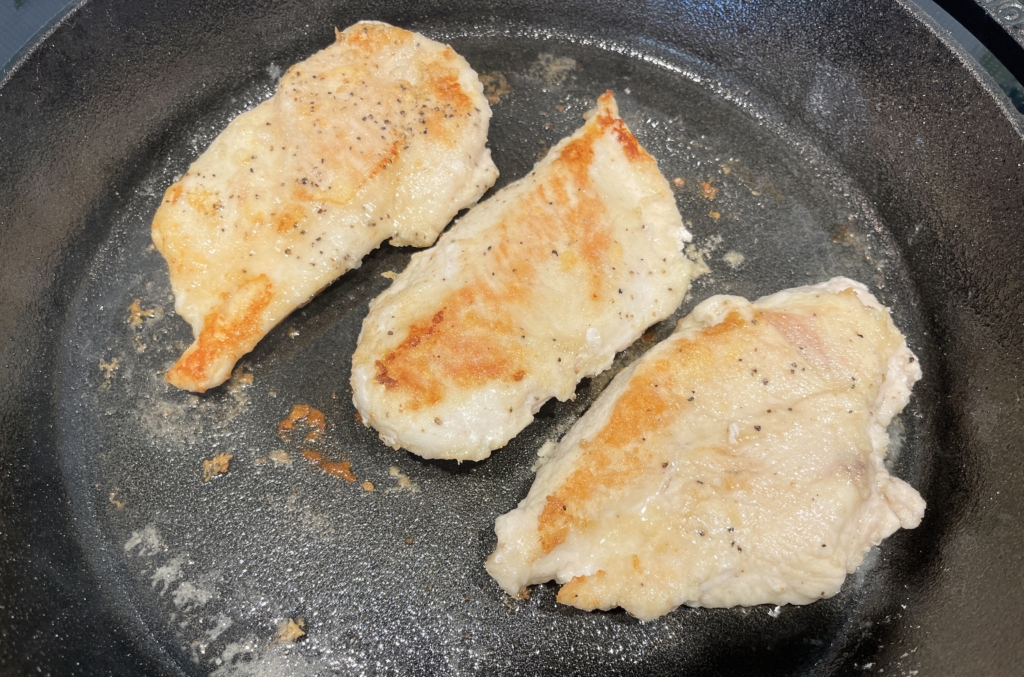 Turn breasts over and cook for an additional 3 mins. Total cooking time is 6 minutes. Remove chicken from the pan and transfer to a plate and tent with foil while cooking the next batch. Repeat. Add another tablespoon of oil to the pan if necessary. Do not clean out pan!
