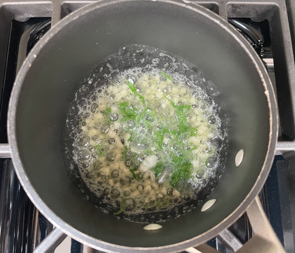 Then add a good pinch or two of the parsley and stir. Remove from the heat. (Butter will be quickly reheated once oysters have been grilled.)