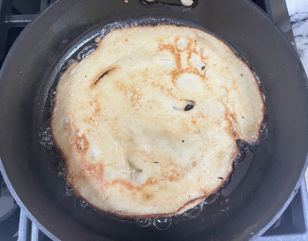 Then carefully flip using a large spatula and cook for another minute, until edges and bottom side are also browned in spots.