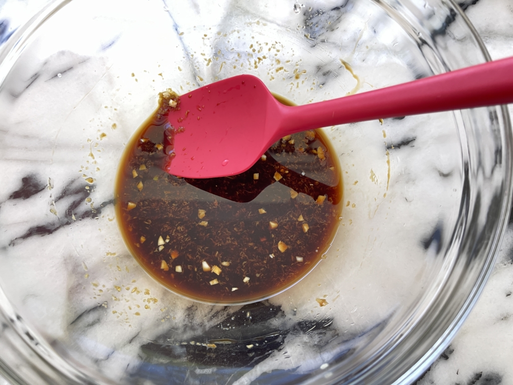 In a large bowl (one that is big enough to fit the chicken!) combine the gluten free soy sauce, ginger, garlic, and sake. Mix well.