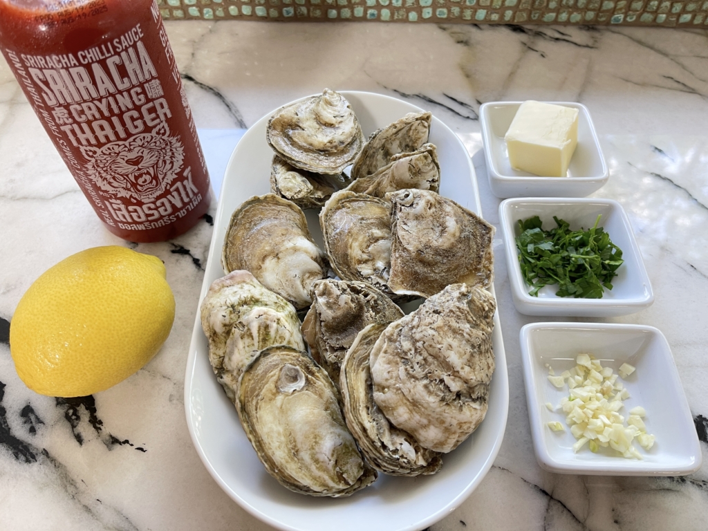 ingredients - whole oysters in the shell, butter, garlic, lemon, parsley, and Sriracha