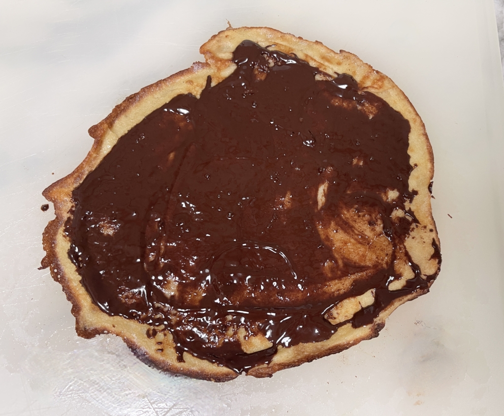 The crepes are delicate so take your time when removing them from the pan. Place crepe onto a plate or cutting board. Spread your filling of choice on the crepe.