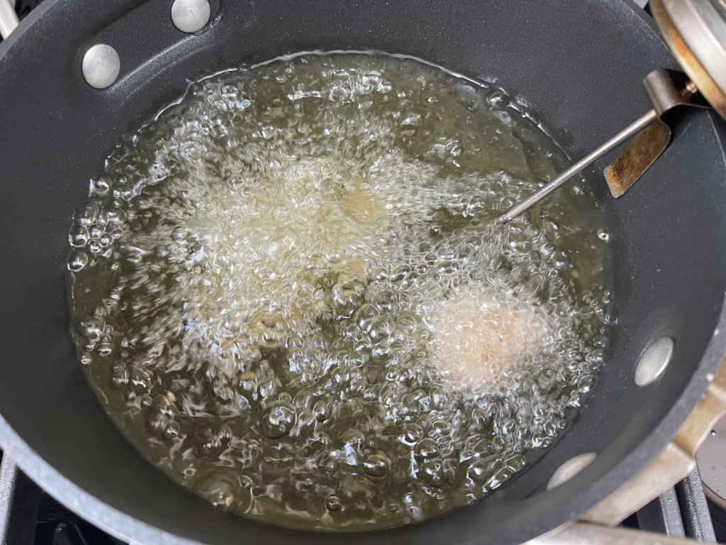 Place oil in a 3 1/2 quart pot. Insert a thermometer and heat oil over medium-high heat to 350 degrees. Once oil is heated, carefully add the chicken pieces in batches, monitoring the oil temperature as you go.