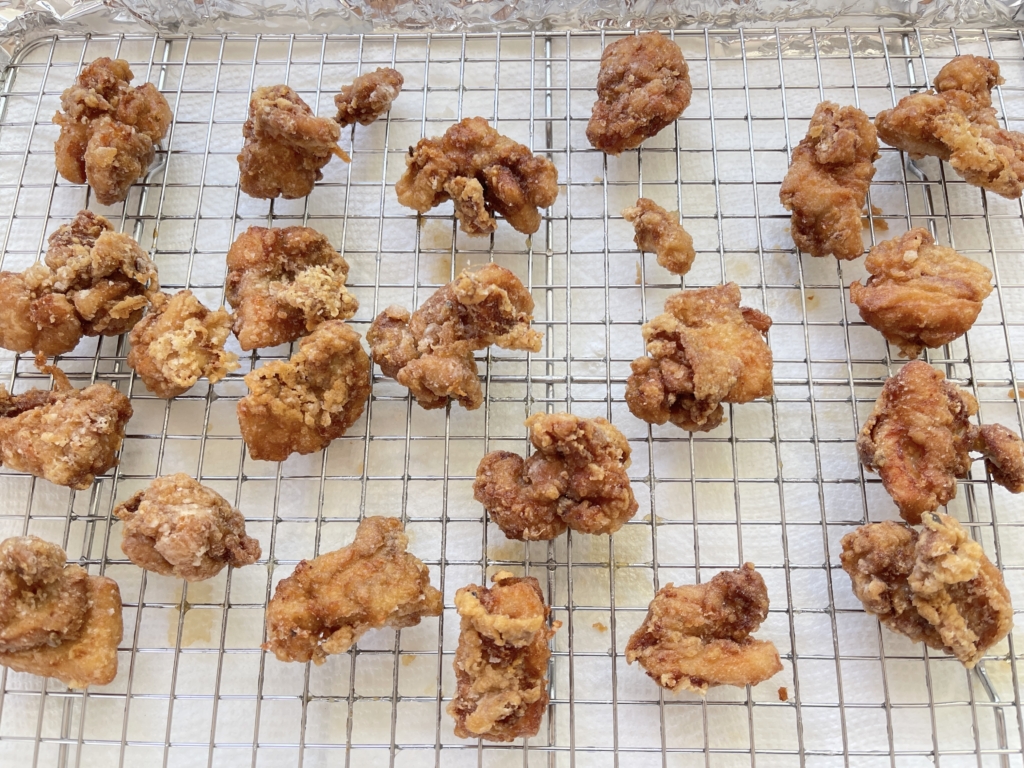 Increase the heat and bring the oil to 360º degrees. Once the oil temperature is reached, begin crisping the chicken in batches of 4-5 pieces again for approximately 60 seconds or until ultra crispy and golden brown. Transfer chicken to the wire rack to drain excess oil.